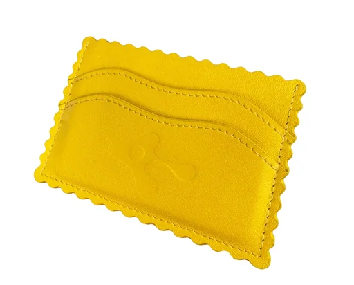 Yellow ravioli card holder at an angle on white, showing its wavy card slots and embossed Ravi mascot
